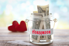 Glass Jar With Money On Wooden Table