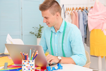 Poster - Young male fashion designer at workplace