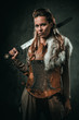 © Nejron Photo - Viking woman with cold weapon in a traditional warrior clothes