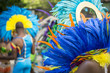 Group of dancers wearing colorful feathers costumes gathered for a gay pride street parade