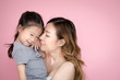 © Jestercine - woman hodling kid with happy emotion, isolated on pink background.