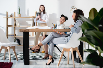 Wall Mural - young multiethnic businesswomen in formal wear working at office together