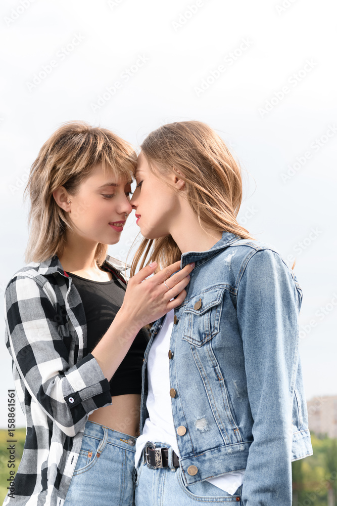 young lesbian kissing teen young lesbian couple kissing with eyes closed outdoors の Stock フォト | Adobe  Stock