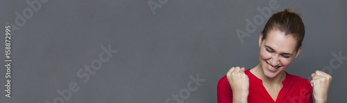 energetic beautiful girl laughing for ecstatic achievement, gray copy space Tableau sur Toile