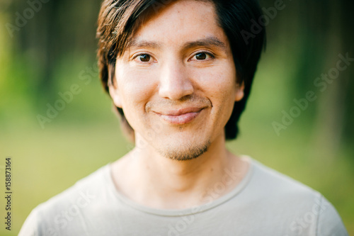 Cuadros en Lienzo Close up portrait of native american peruvian indian redskin man with black hair, dark eyes looking at camera with deep reflective and stare eyes