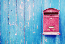 Red Mailbox On Blue Wooden Door