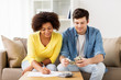 © Syda Productions - happy couple with papers and calculator at home