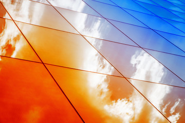 Poster - Modern glass architecture with reflection of red and blue sunset sky. Dramatic bright color. Vintage style background.