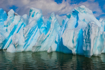 Wall Mural - Azure shimmering beautiful iceberg in Antarctica with green reflection. 