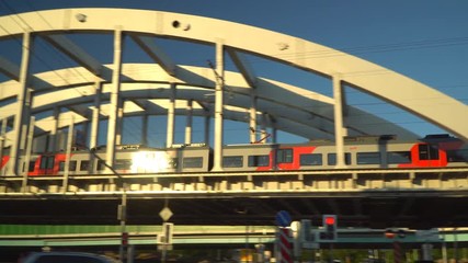 Wall Mural - sun glare on a modern train , moving on the steel overpass