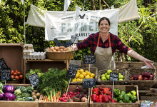 Greengrocer Selling Organic Fresh Agricultural Product At Farmer Market