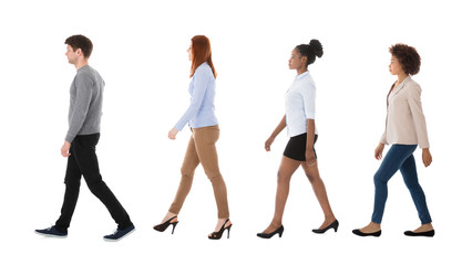 Wall Mural - Male And Female College Students Walking In Row