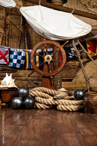 Fotografie, Obraz Pirates ship deck with steering wheel and flag