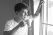 © Jestercine - Asian man drinking coffee at the morning, black and white tone.