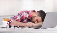Man Sleeping Above Laptop At Home