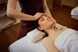 © Studio Romantic - Beautiful woman is given a face massage at the spa salon.