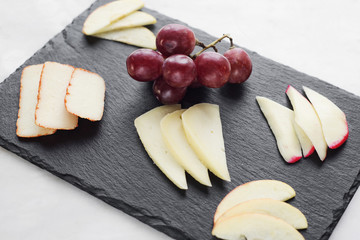 Wall Mural - gourmet mixed cheese board tapas starter with apple and grapes