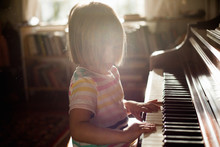 Girl At Home Playing Old Piano