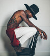 © kkgas/Stocksy - Young tattooed black man modelling