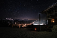 Friends In Jacuzzi In Snowcovered Mountain Landscape Under Dark Starry Nightsky