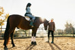 © BONNINSTUDIO/Stocksy - Women riding a horse on a farm