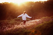 © HOWL/Stocksy - young woman runs through  field