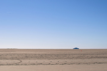 Wall Mural - very big sand space with a blue background sky