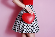 Fashion Small Red Bag In Hand Of Girl . Polka Dots Skirt