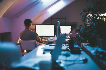 Programmer Writing a Computer Code at His Office at Night