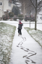 Boy Making Zig Zag Tracks In First Snow Of The Season 