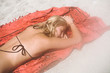 © Simone Becchetti/Stocksy - Woman lying in the beach under the sun