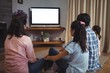 © wavebreak3 - Family watching television together in living room
