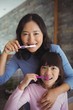 © WavebreakMediaMicro - Mother and daughter brushing teeth in the bathroom