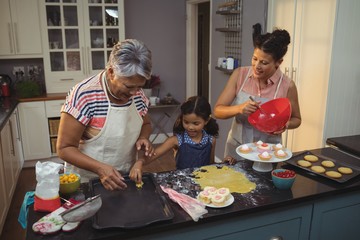 Wall Mural - Happy family preparing desserts in kitchen