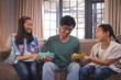 © WavebreakMediaMicro - Father receiving gifts from siblings in living room