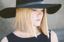 Portrait Of Young Blond Woman With Black Hat 
