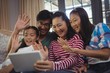 © WavebreakMediaMicro - Family having a video call on laptop in living room