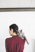 Woman From Behind With Grey Cat On The Shoulder