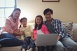 © WavebreakMediaMicro - Family using laptop together in living room