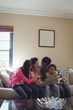 © WavebreakMediaMicro - Family using laptop together in living room