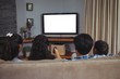 © WavebreakMediaMicro - Family watching television together in living room