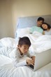 © wavebreak3 - Boy using laptop in bedroom