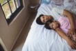 © wavebreak3 - Father and daughter sleeping together in bedroom
