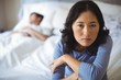 © wavebreak3 - Upset woman sitting on bed in bedroom