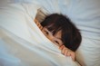 © wavebreak3 - Boy hiding in bed under the blanket