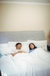 © wavebreak3 - Couple sleeping on bed in bedroom