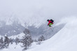 © Leander Nardin/Stocksy - young male freerider skiing down a powder slope
