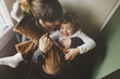 © Rob and Julia Campbell/Stocksy - Young mother cuddling with toddler girl laughing