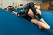© Sean Locke/Stocksy - Gymnastics Team Of Gymnasts Stretch Out Before Practice