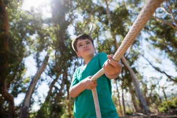Wall Mural - boy practicing tug of war during obstacle course training